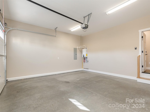 garage featuring electric panel, tankless water heater, and a garage door opener