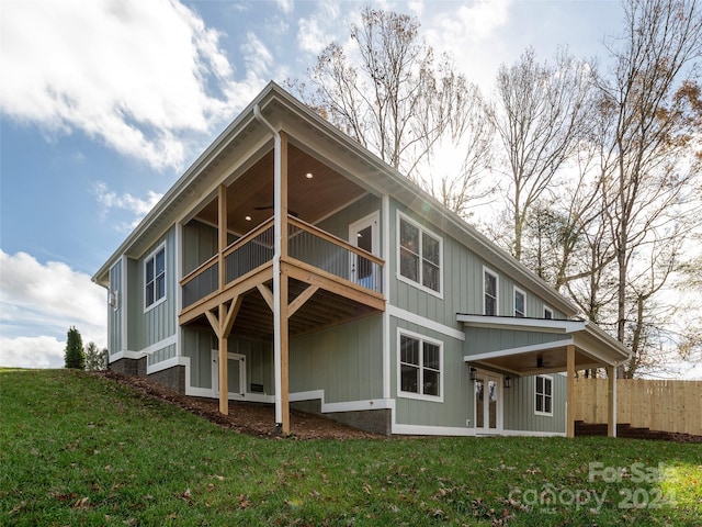 rear view of property with a yard