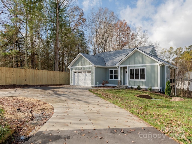 view of front of home featuring a front lawn and a garage