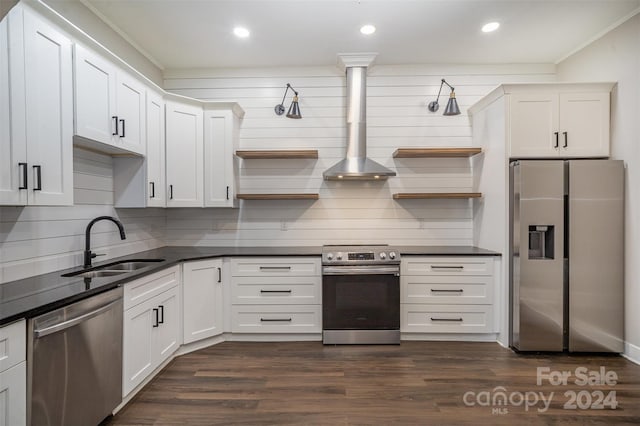 kitchen featuring stainless steel appliances, wall chimney range hood, white cabinets, and dark hardwood / wood-style flooring