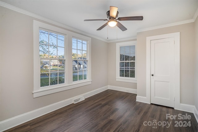 spare room featuring dark hardwood / wood-style flooring, ceiling fan, and crown molding