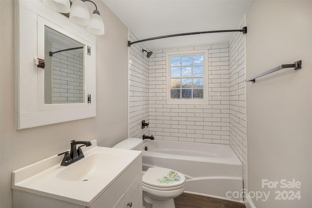 full bathroom with wood-type flooring, tiled shower / bath combo, toilet, and vanity