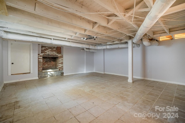 basement featuring a brick fireplace