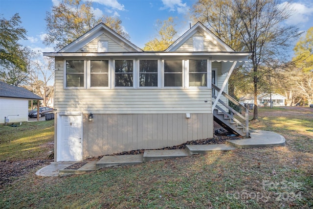 view of side of property featuring a sunroom