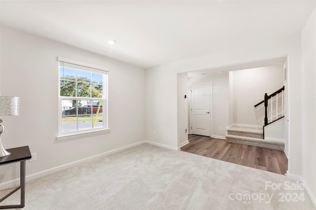 unfurnished room featuring light carpet