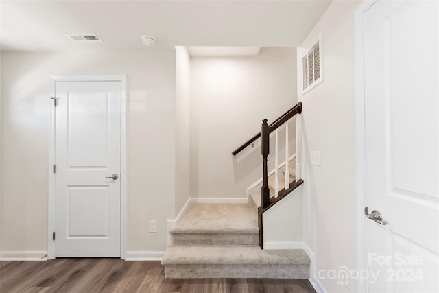 stairs with wood-type flooring