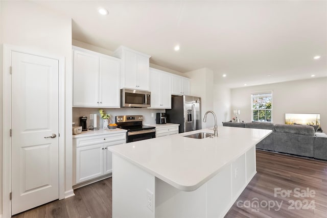 kitchen featuring a center island with sink, stainless steel appliances, dark hardwood / wood-style floors, sink, and white cabinets