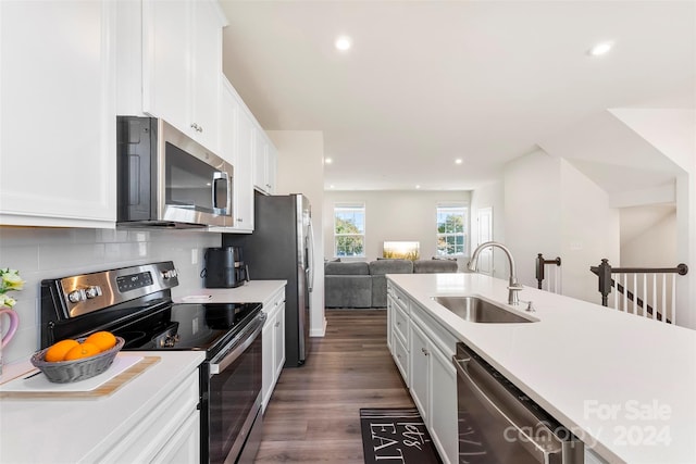 kitchen with white cabinets, stainless steel appliances, dark wood-type flooring, and sink