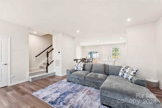 living room featuring sink and light wood-type flooring