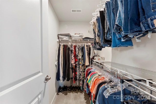 walk in closet with carpet floors