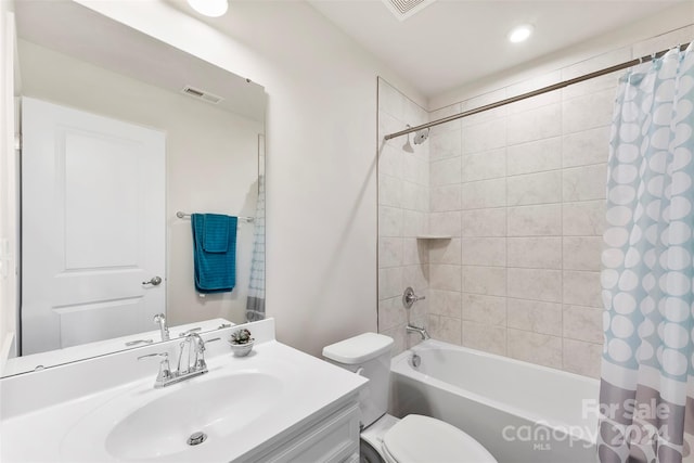 full bathroom featuring vanity, shower / bath combination with curtain, and toilet