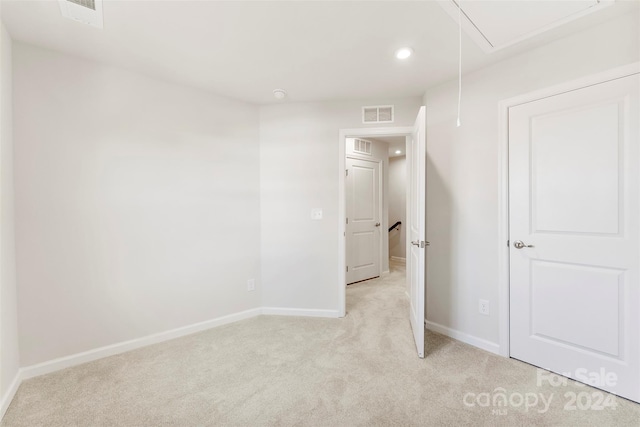 spare room featuring light colored carpet