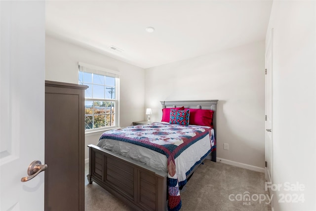 bedroom with light colored carpet