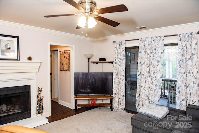 living room featuring ceiling fan, crown molding, and dark wood-type flooring