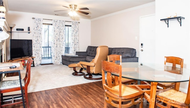 dining space with dark hardwood / wood-style flooring, ceiling fan, and ornamental molding