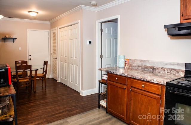 kitchen featuring dark hardwood / wood-style flooring, range hood, black range with electric cooktop, and ornamental molding