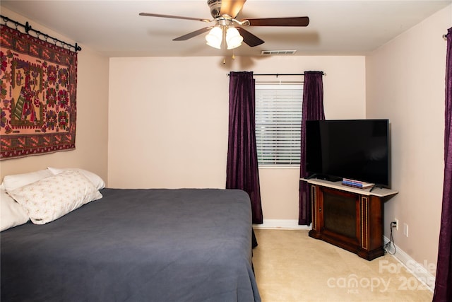 bedroom with ceiling fan and light colored carpet