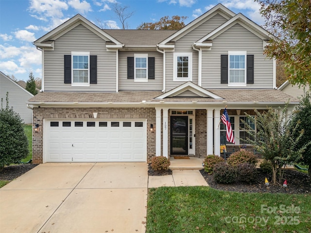 view of front of house with covered porch and a garage