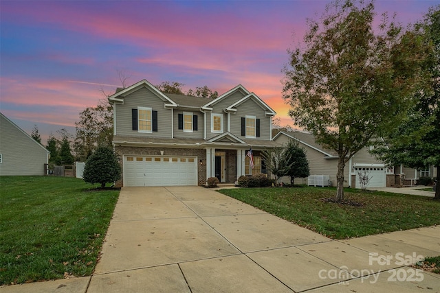 front of property with a lawn and a garage