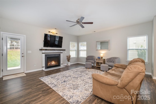 living room featuring ceiling fan, dark hardwood / wood-style flooring, and plenty of natural light