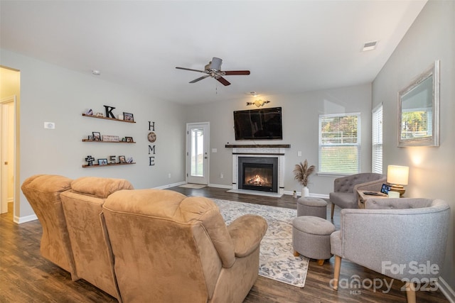 living room with ceiling fan and dark hardwood / wood-style floors