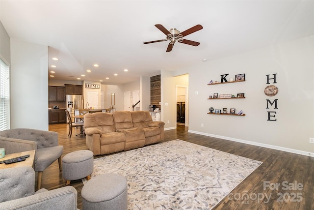 living room featuring dark hardwood / wood-style flooring and ceiling fan