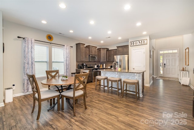 dining area with sink and dark hardwood / wood-style floors