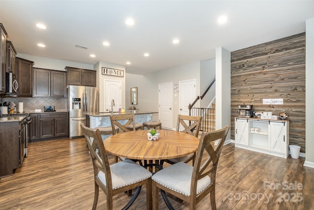 dining room with sink and dark hardwood / wood-style floors