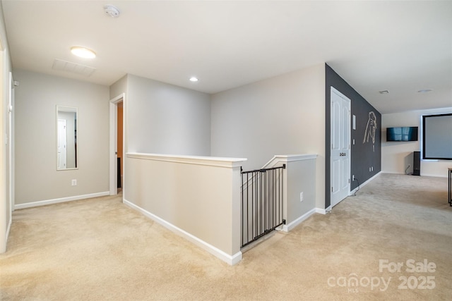 hallway featuring light carpet