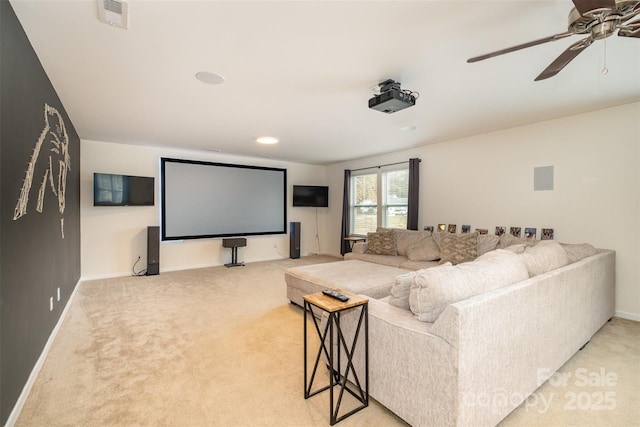 cinema room featuring ceiling fan and carpet flooring