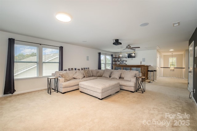 living room with ceiling fan and light colored carpet