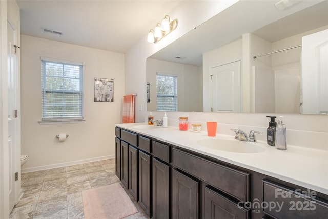 bathroom featuring vanity and toilet