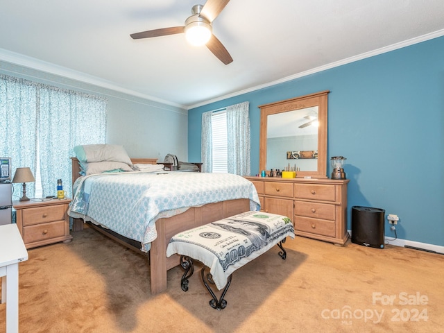 bedroom featuring light carpet, ceiling fan, and crown molding