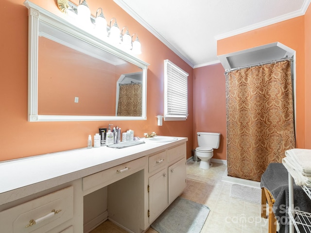 bathroom with toilet, vanity, and ornamental molding