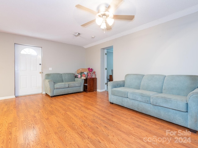 living room featuring light hardwood / wood-style floors and ceiling fan