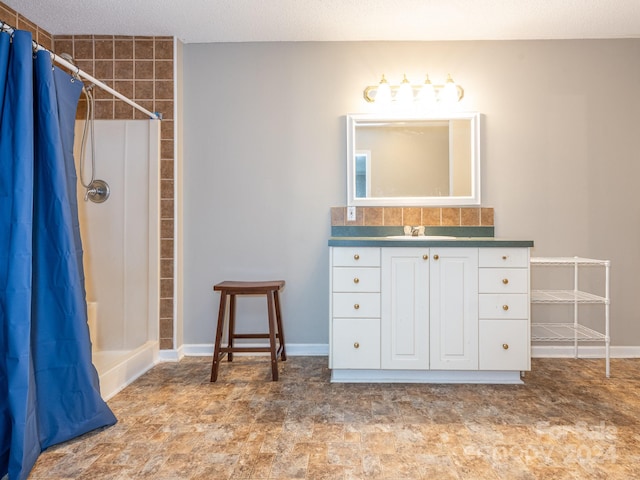 bathroom featuring vanity, a textured ceiling, and walk in shower