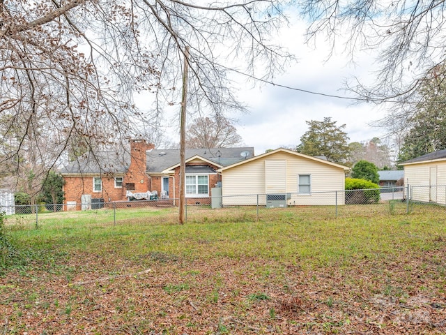 rear view of house with a lawn