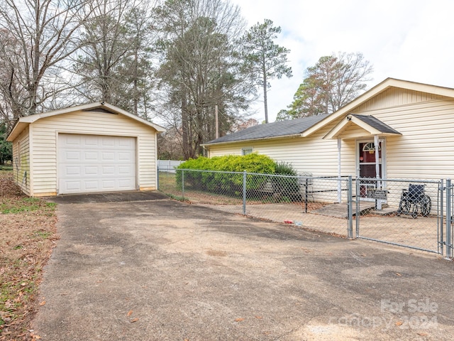 view of front facade with an outbuilding and a garage