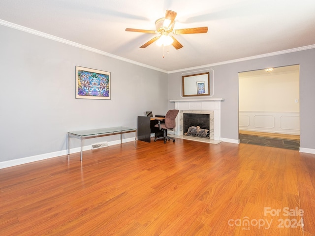 unfurnished office with hardwood / wood-style floors, ceiling fan, and ornamental molding