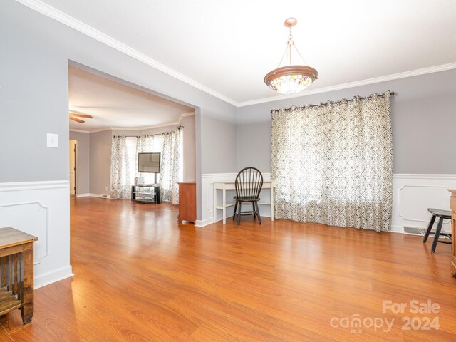 unfurnished room featuring crown molding and hardwood / wood-style flooring