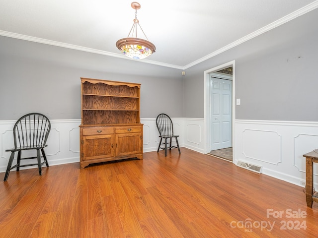 interior space with light wood-type flooring and ornamental molding