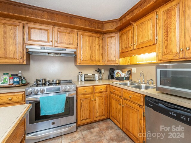 kitchen featuring sink, light tile patterned flooring, and appliances with stainless steel finishes