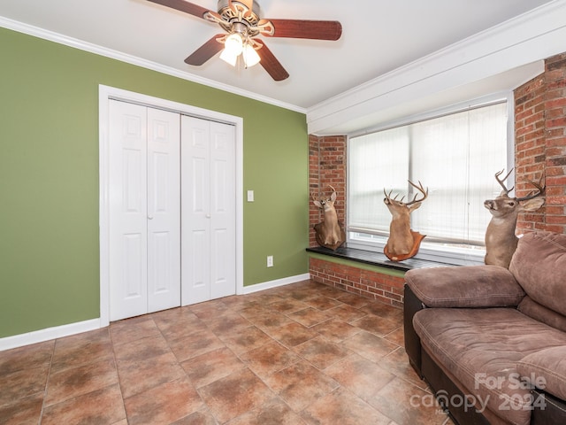 living area with ceiling fan and ornamental molding