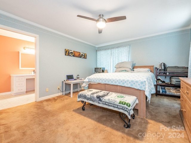 carpeted bedroom with ceiling fan, ensuite bathroom, and ornamental molding