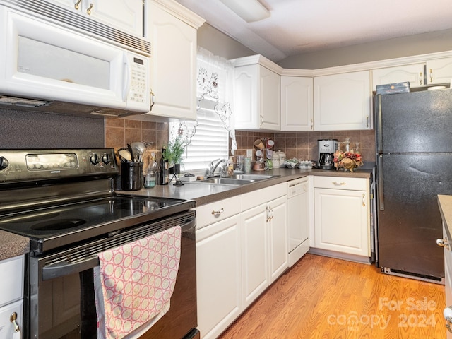 kitchen with decorative backsplash, white cabinetry, white appliances, and sink