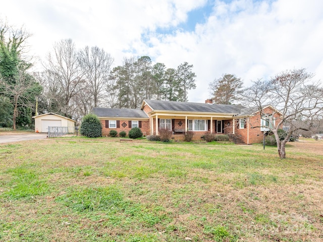 ranch-style home with an outbuilding, a garage, and a front lawn