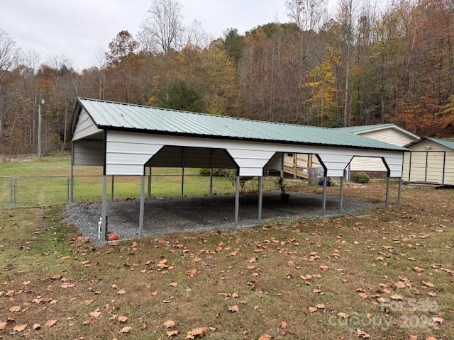 1922 Zacks Fork Rd, Lenoir, NC 28645 - view of outbuilding with a detached carport and a wooded view