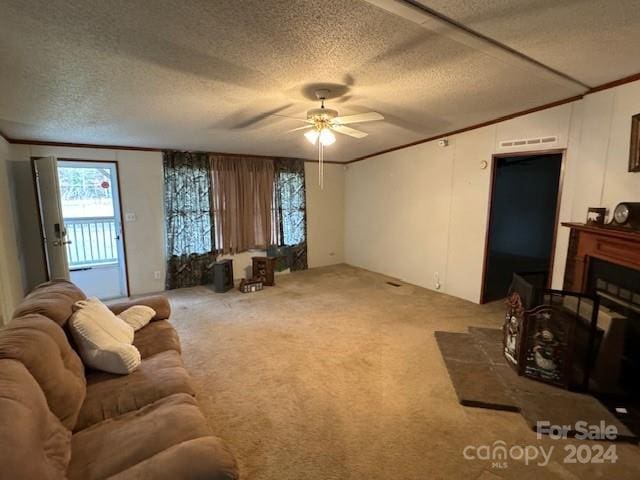 carpeted living room with ceiling fan, a textured ceiling, and crown molding