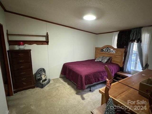 carpeted bedroom with a textured ceiling and crown molding