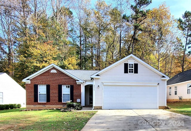 single story home with a garage and a front lawn